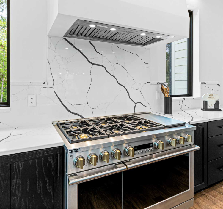 Modern kitchen with dark wood cabinets and white marble countertops, showcasing the elegance of StarMark Cabinetry.