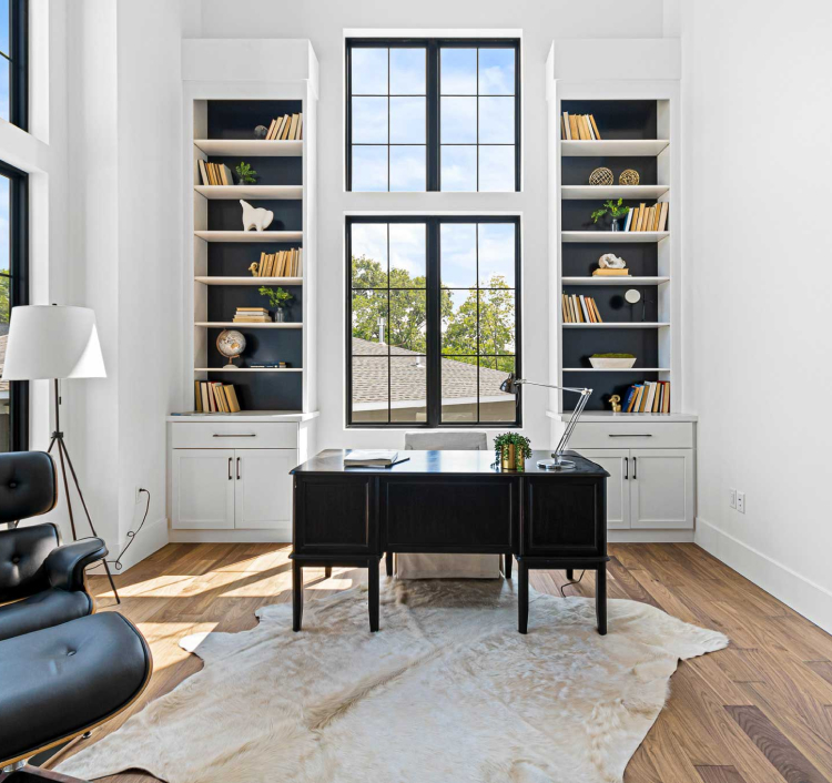 Home office with built-in white cabinets, illustrating custom storage solutions with StarMark Cabinetry.