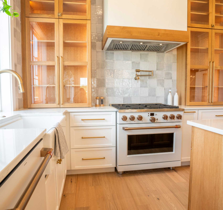 Warm kitchen with light wood cabinetry and glass doors, highlighting the timeless quality of StarMark Cabinetry.